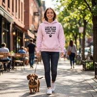 Load image into Gallery viewer, A woman walking a dachshund on a city sidewalk wearing a light pink hoodie with the text 'I LIKE MY DOG MORE THAN I LIKE YOU. (Yes, you.)